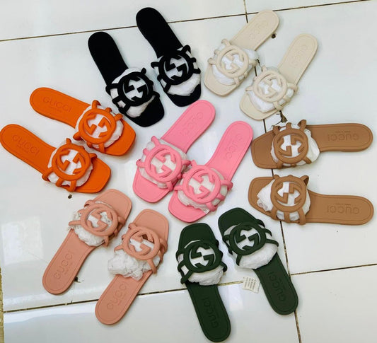 Collection of colorful slides with brand logo on a tiled floor