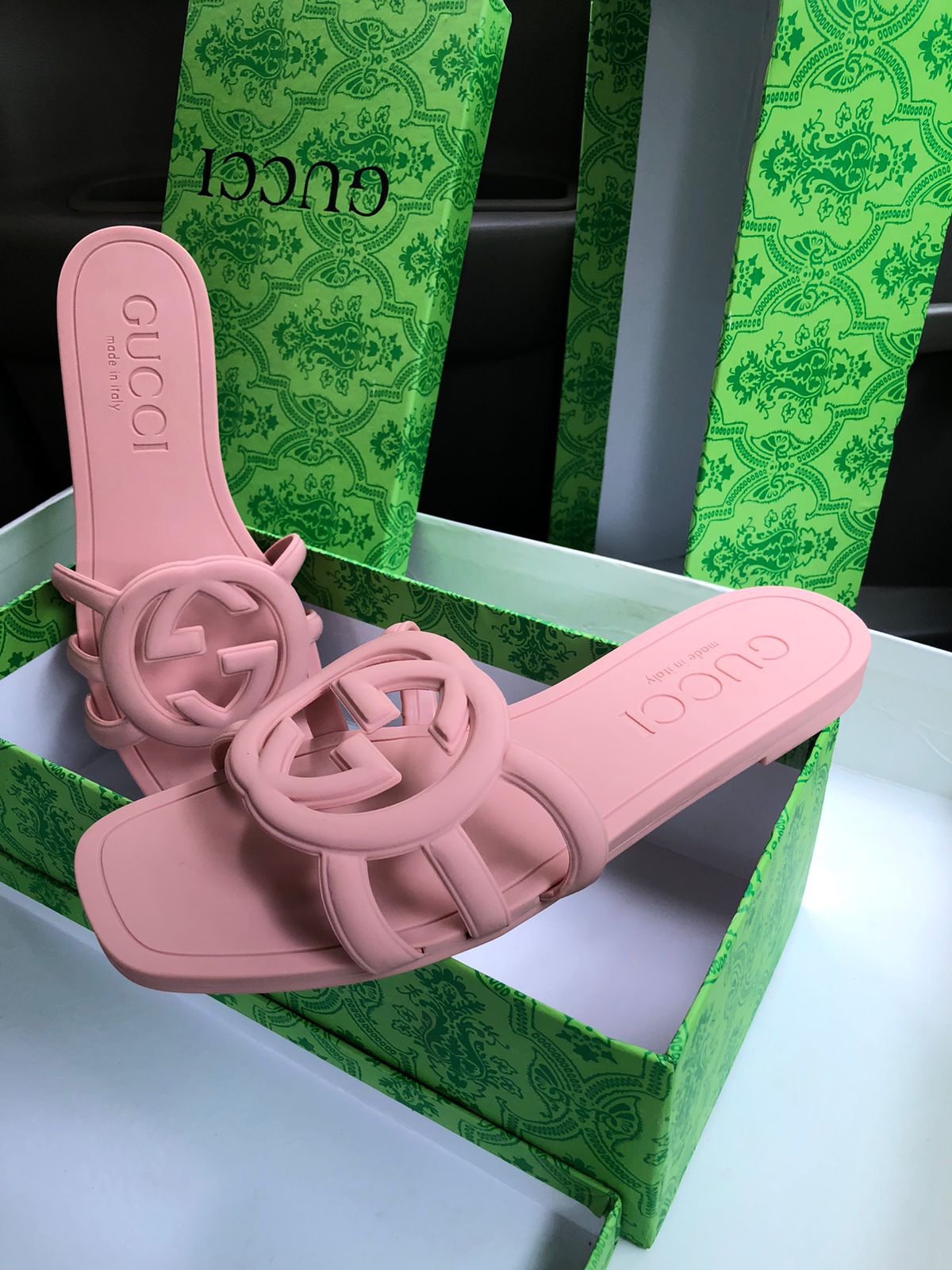 Pink Guc ci sandals on a green Guc ci box