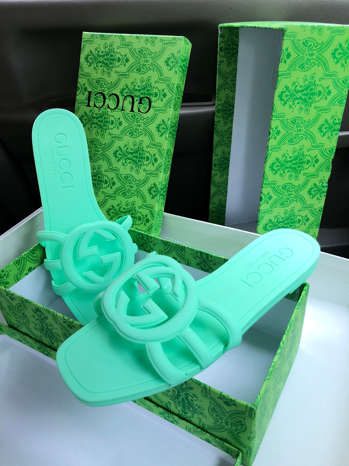Green cookie cutters with Guc ci branding on a white surface