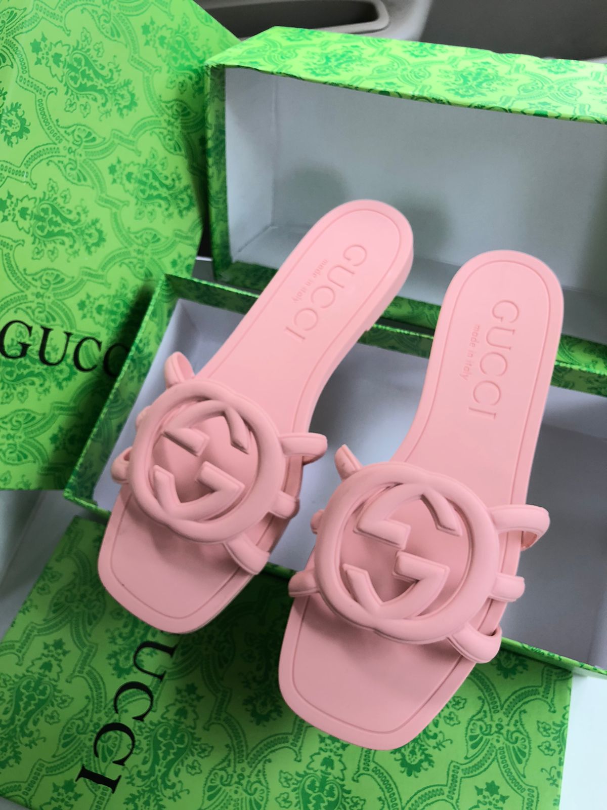 Pink Guc ci sandals on a green Guc ci box