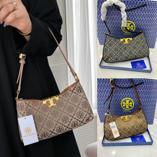 To ry Bur ch handbag with gold clasp and patterned design, displayed against a white background.