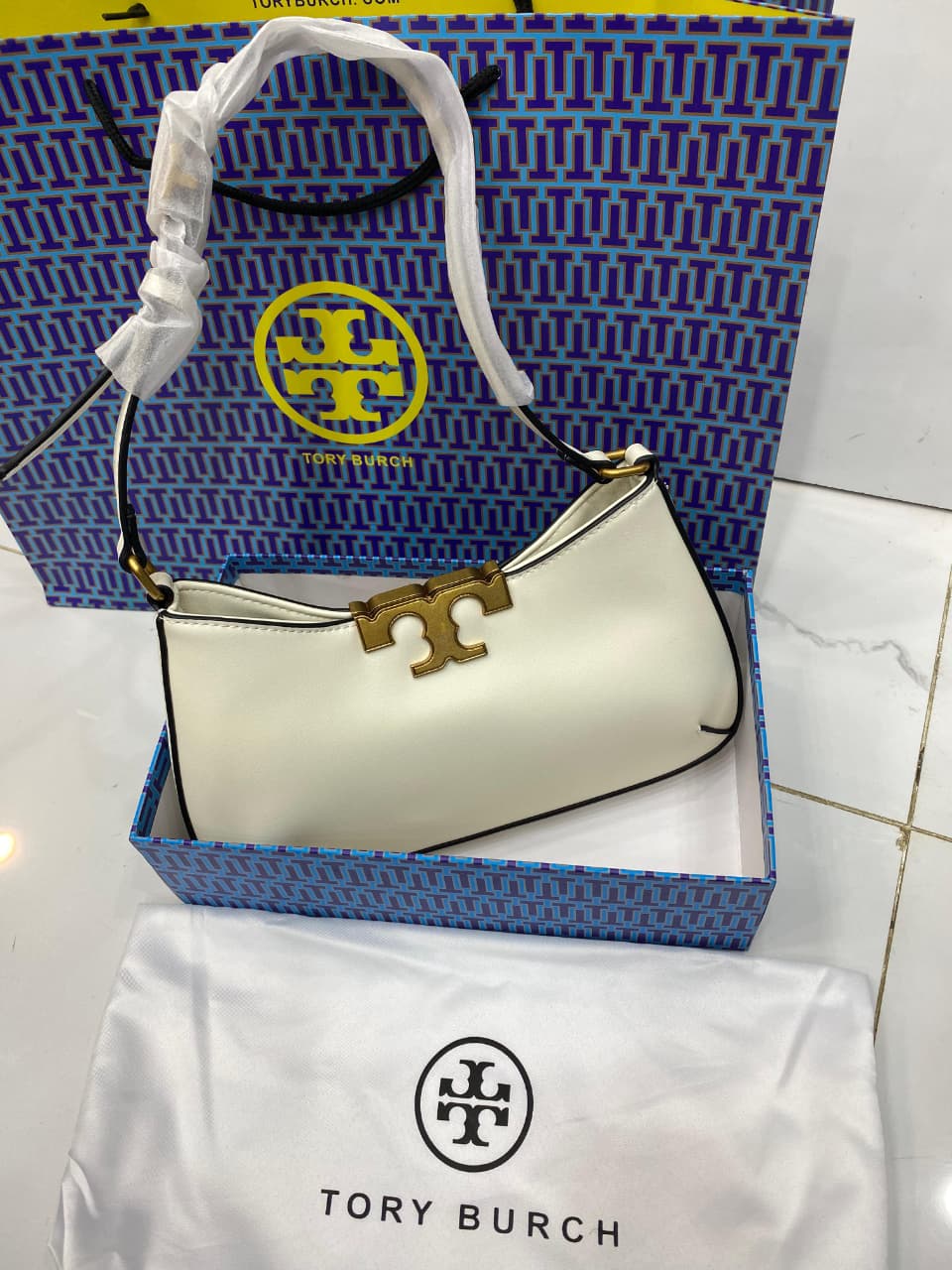 To ry Bur ch handbag with logo on a branded box and bag