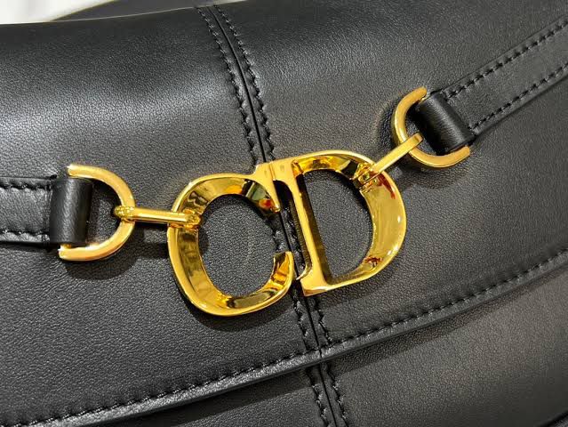 Black leather handbag with gold chain detail