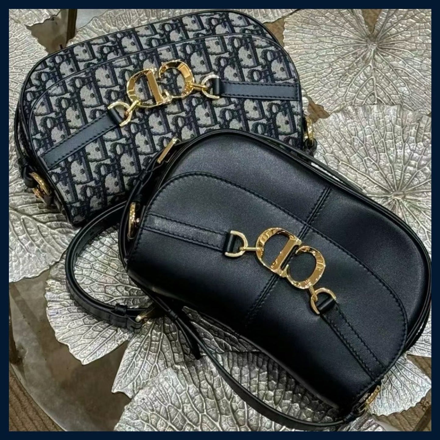 Black handbag with gold hardware on a textured surface