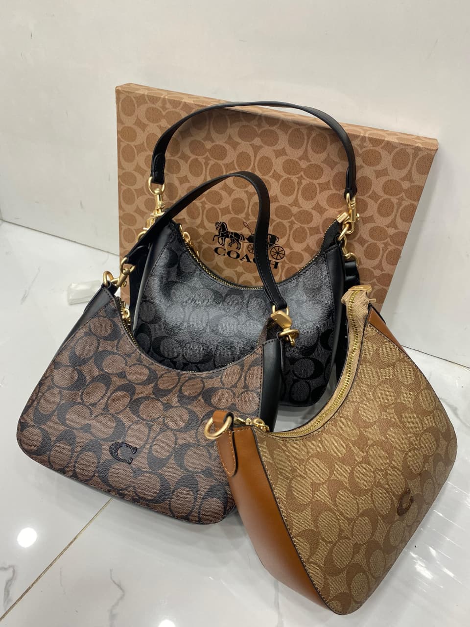 Co-ach handbag with patterned design on a white surface