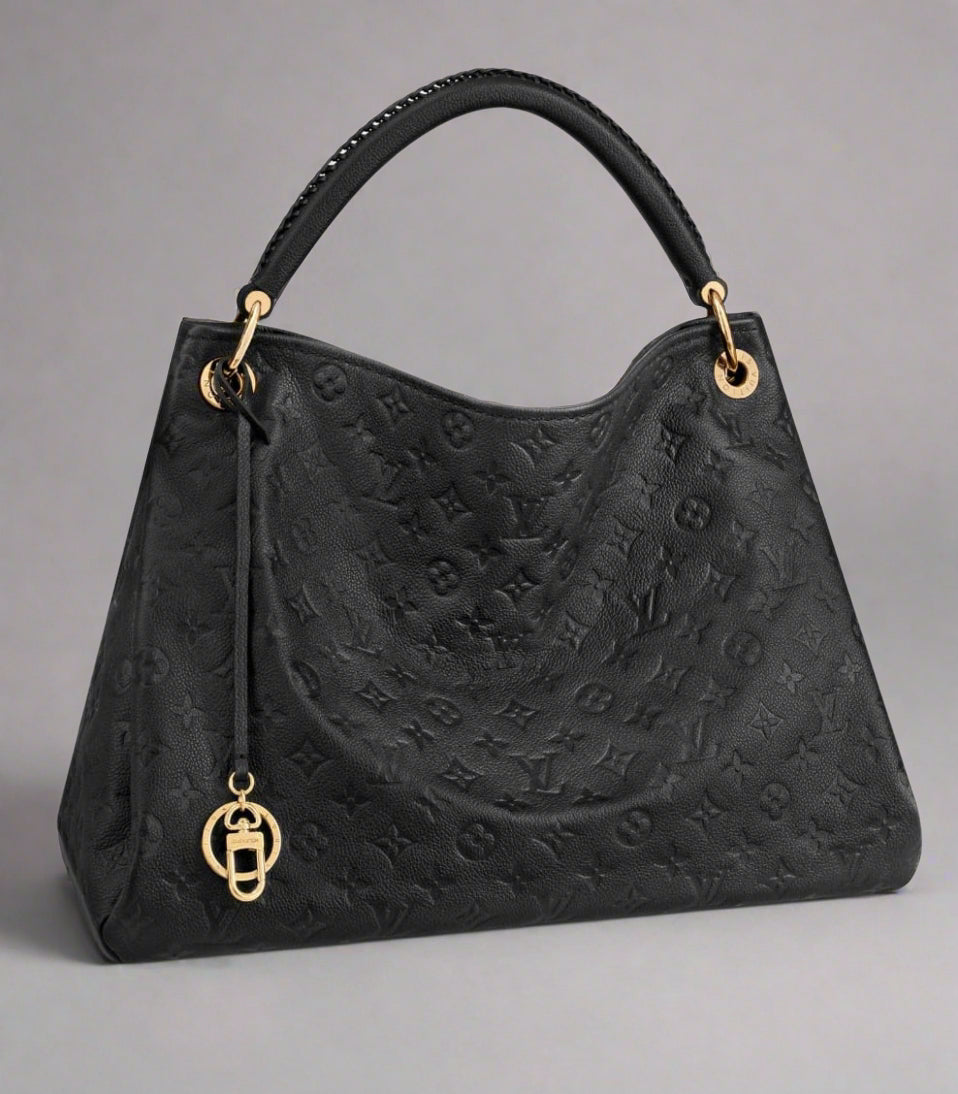 Black handbag with gold accents on a white background