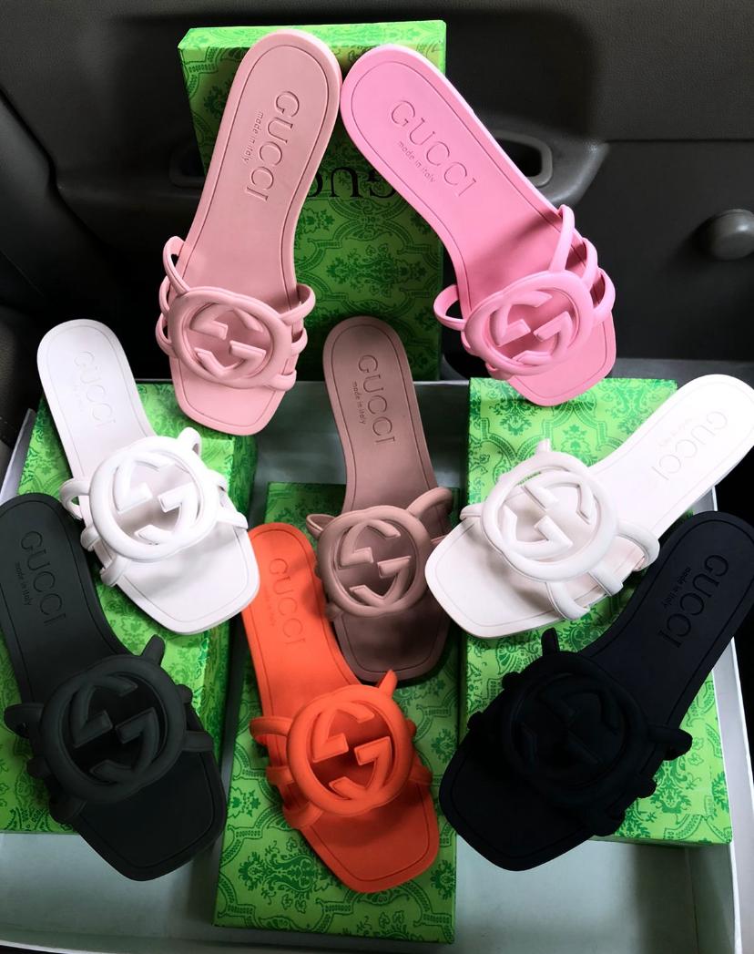 Colorful sandals with floral designs on a green surface