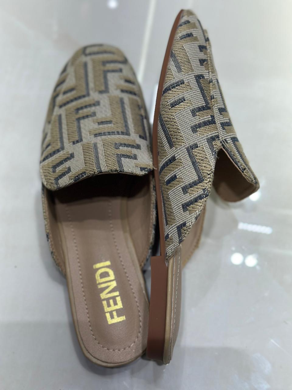 Pair of Fendi loafers on a white background